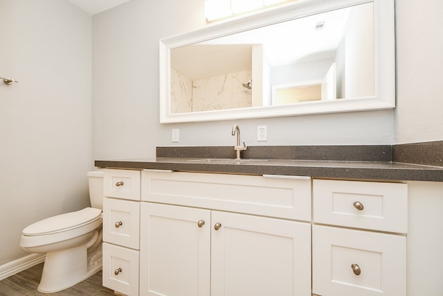 bathroom featuring vanity, toilet, and wood-type flooring