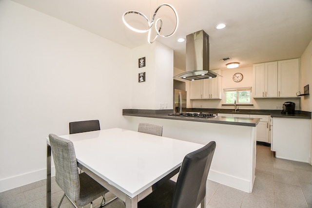 dining area with sink and light tile patterned flooring