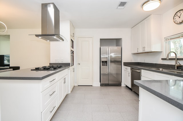 kitchen featuring island range hood, sink, white cabinets, and stainless steel appliances