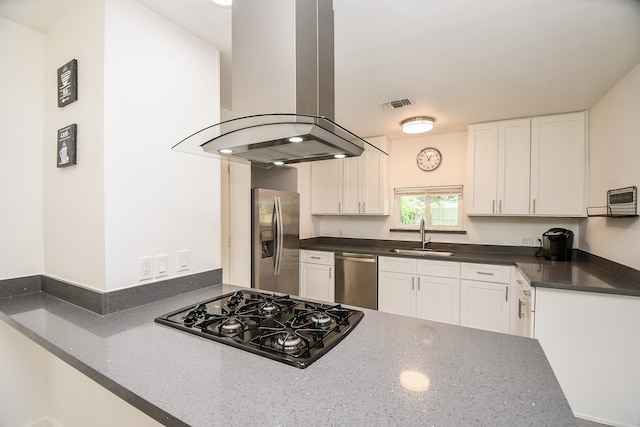 kitchen featuring island exhaust hood, kitchen peninsula, sink, white cabinetry, and appliances with stainless steel finishes