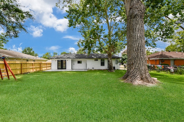 back of house featuring a yard and a patio area