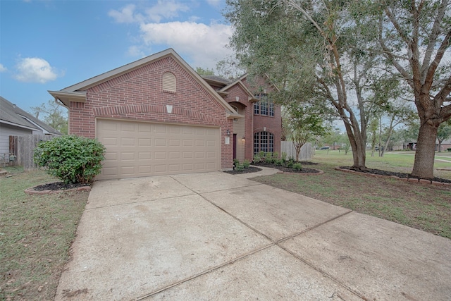 view of property with a garage and a front lawn