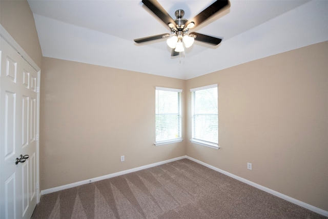 carpeted spare room featuring ceiling fan