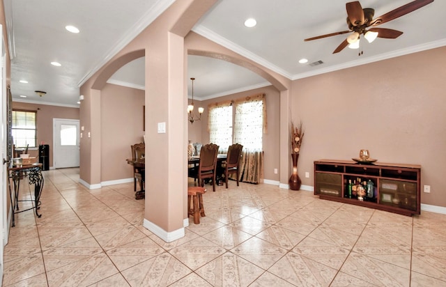 dining space featuring ornamental molding and ceiling fan with notable chandelier