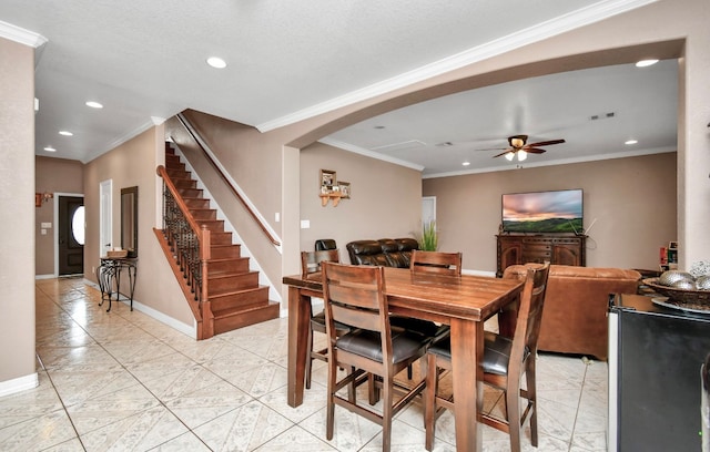 dining room featuring crown molding and ceiling fan