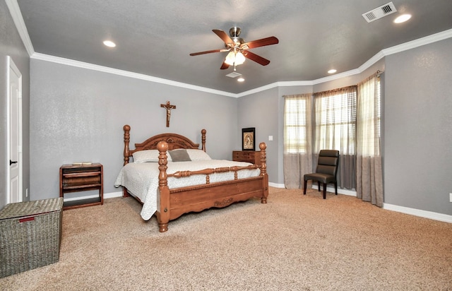 bedroom with ceiling fan, crown molding, and carpet