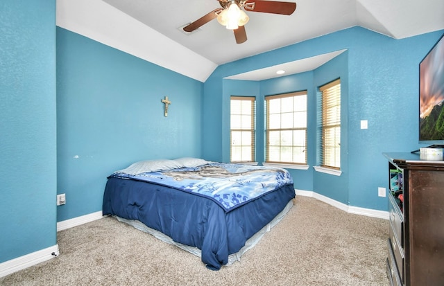 bedroom with vaulted ceiling, light colored carpet, and ceiling fan