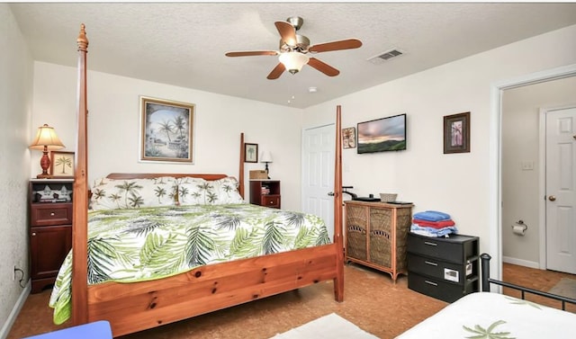 bedroom featuring ceiling fan and a textured ceiling