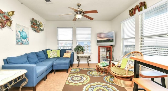 living room with ceiling fan and plenty of natural light