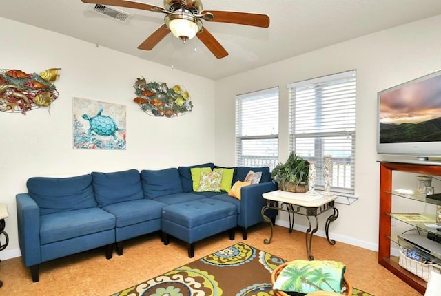 carpeted living room featuring ceiling fan