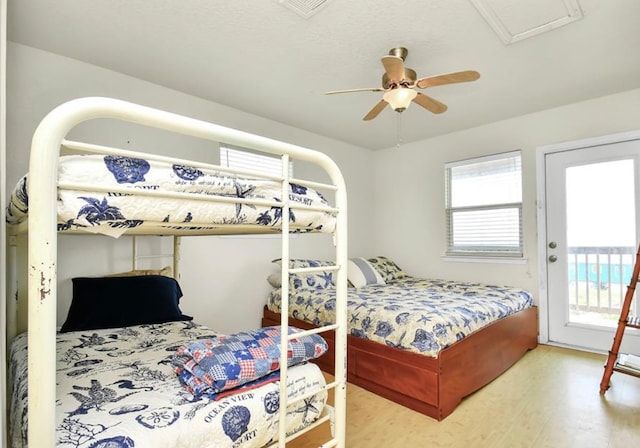 bedroom featuring ceiling fan, access to outside, and hardwood / wood-style floors