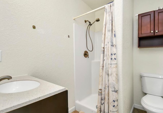 bathroom with vanity, toilet, and curtained shower