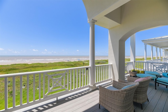 1745 Seaside Dr, Galveston, TX 77550 - wooden deck featuring a water view and a beach view