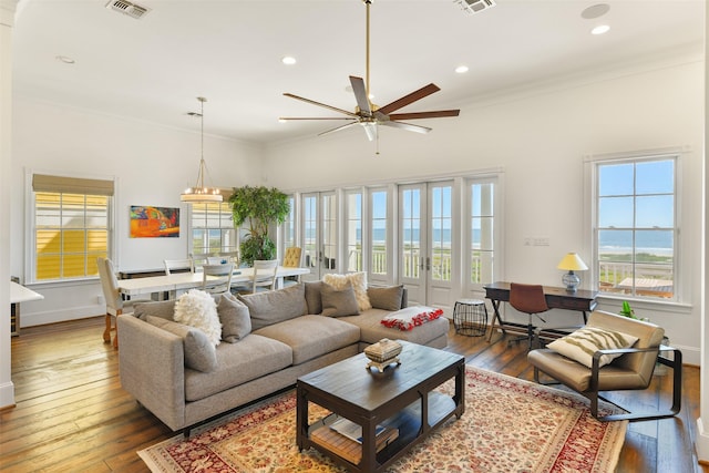 1745 Seaside Dr, Galveston, TX 77550 - living room featuring visible vents, recessed lighting, crown molding, wood-type flooring, and a ceiling fan