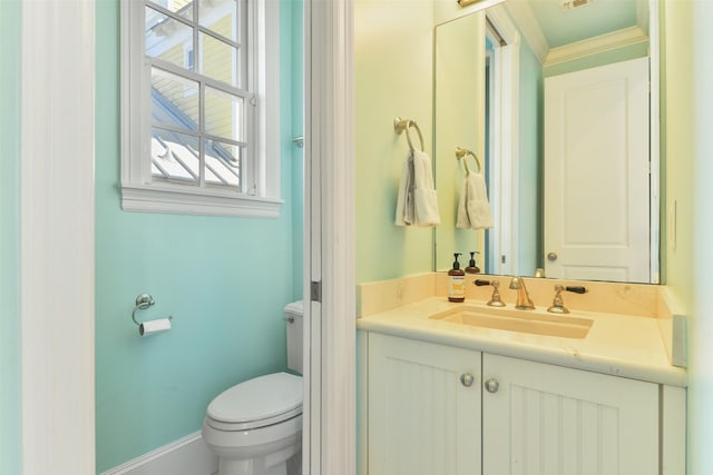 1745 Seaside Dr, Galveston, TX 77550 - bathroom featuring toilet, vanity, visible vents, crown molding, and baseboards