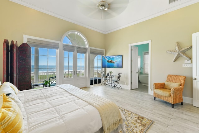 1745 Seaside Dr, Galveston, TX 77550 - bedroom with multiple windows, a water view, access to exterior, and crown molding