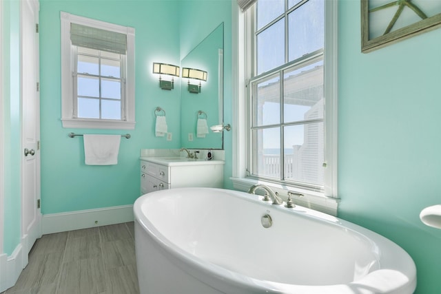 1745 Seaside Dr, Galveston, TX 77550 - bathroom with a freestanding bath, baseboards, and vanity