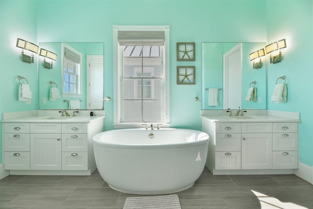 1745 Seaside Dr, Galveston, TX 77550 - full bathroom with a sink, a freestanding bath, and two vanities