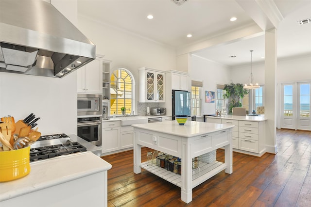 1745 Seaside Dr, Galveston, TX 77550 - kitchen featuring ventilation hood, white cabinets, glass insert cabinets, and appliances with stainless steel finishes