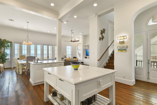 1745 Seaside Dr, Galveston, TX 77550 - kitchen featuring dark wood-type flooring, recessed lighting, white cabinetry, a ceiling fan, and a kitchen island