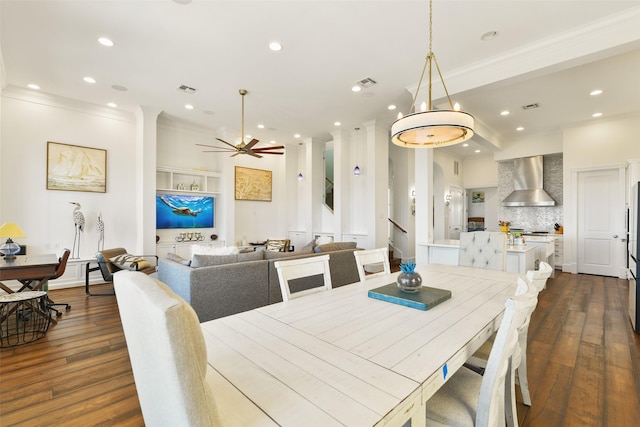 1745 Seaside Dr, Galveston, TX 77550 - dining room with dark wood finished floors, visible vents, ornamental molding, and recessed lighting