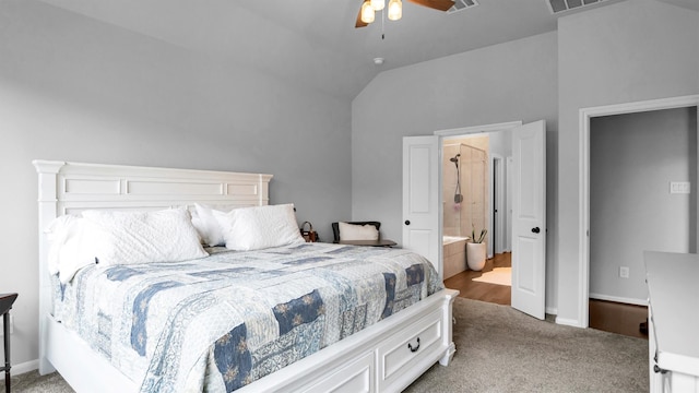 carpeted bedroom with connected bathroom, ceiling fan, and vaulted ceiling