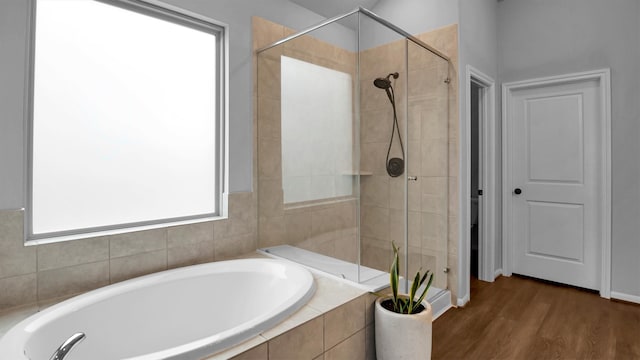 bathroom featuring hardwood / wood-style flooring and independent shower and bath