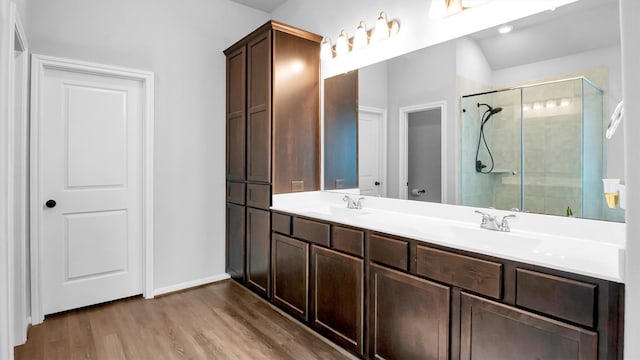 bathroom with vanity, wood-type flooring, and an enclosed shower