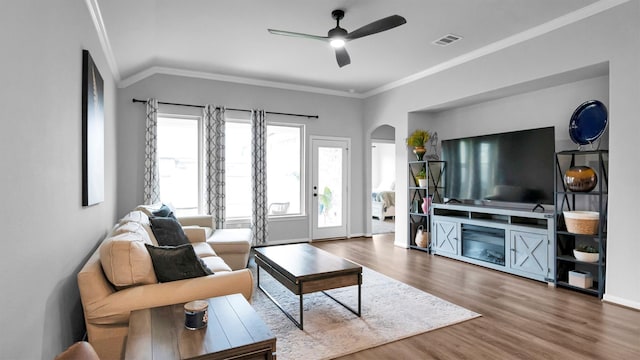 living room featuring crown molding, vaulted ceiling, wood-type flooring, and ceiling fan