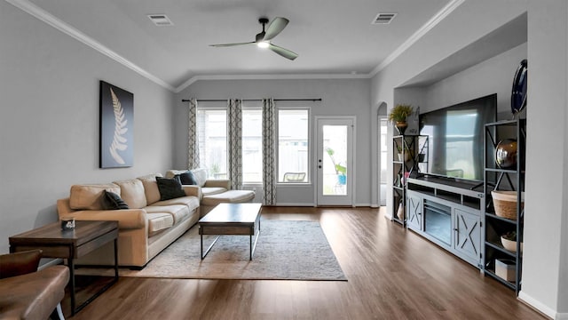 living room featuring crown molding, hardwood / wood-style flooring, vaulted ceiling, and ceiling fan