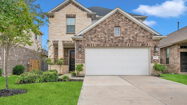 front facade featuring a garage and a front lawn