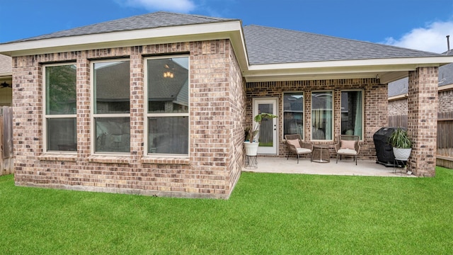 rear view of house featuring a patio area and a lawn