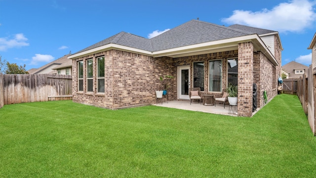 back of house featuring a yard and a patio