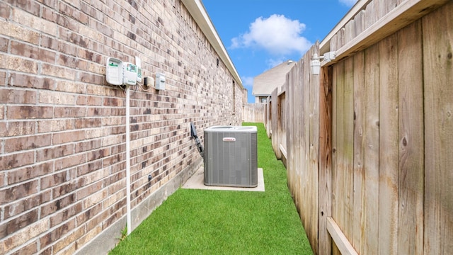 exterior space featuring cooling unit, carpet flooring, and wood walls