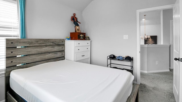 bedroom with vaulted ceiling and light carpet