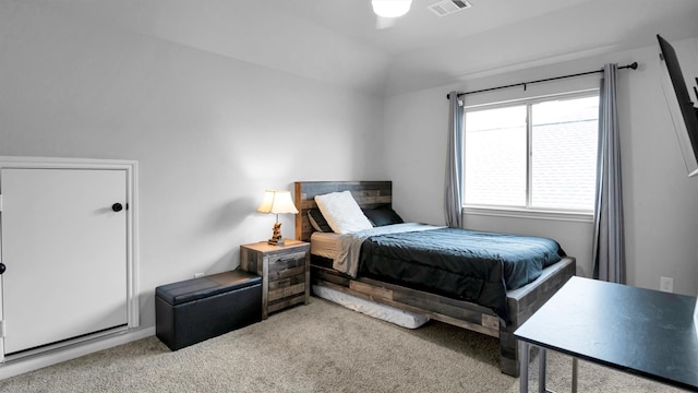 carpeted bedroom featuring lofted ceiling