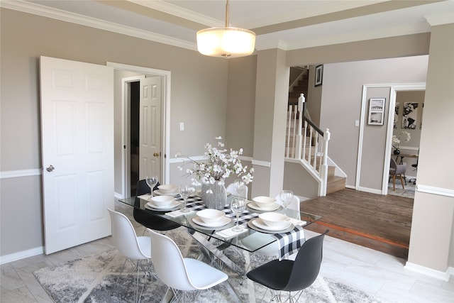 dining room featuring ornamental molding and light hardwood / wood-style flooring