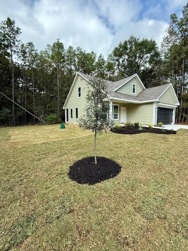 view of front facade with a front yard and a garage