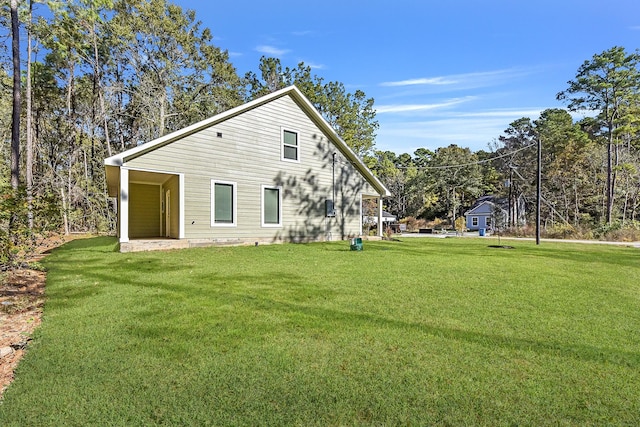 rear view of house featuring a yard