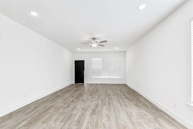 spare room featuring light hardwood / wood-style floors and ceiling fan