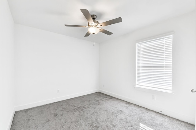 unfurnished room featuring light carpet, ceiling fan, and a healthy amount of sunlight