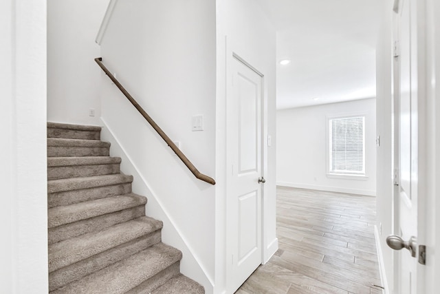 stairs with wood-type flooring