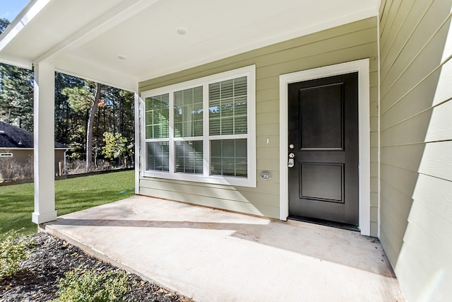 doorway to property with a yard