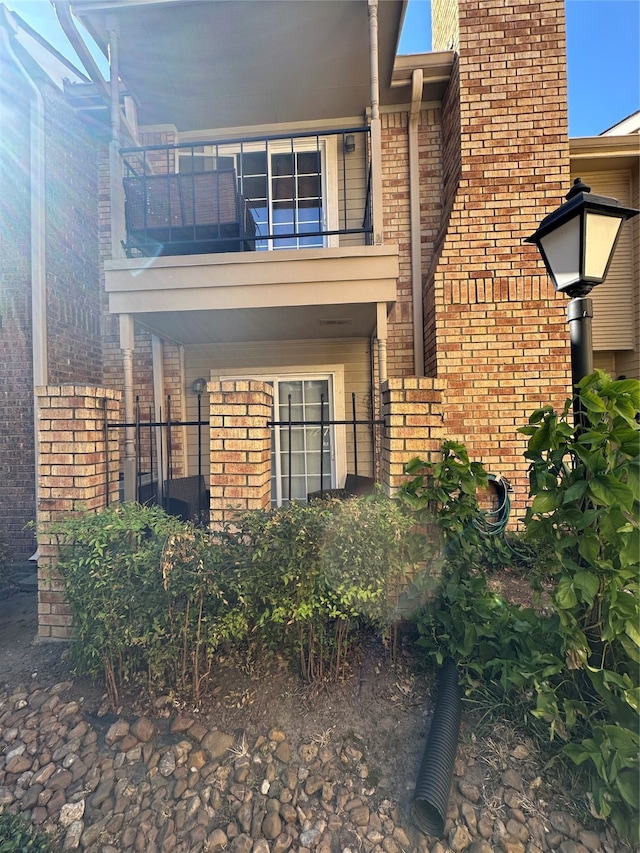 back of property featuring a balcony