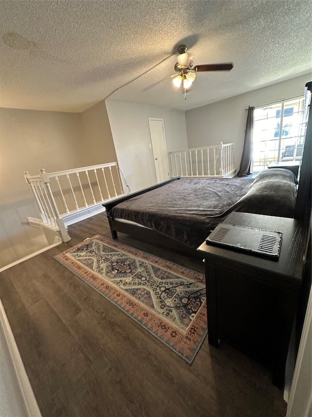 bedroom with dark wood-type flooring, pool table, a textured ceiling, and ceiling fan