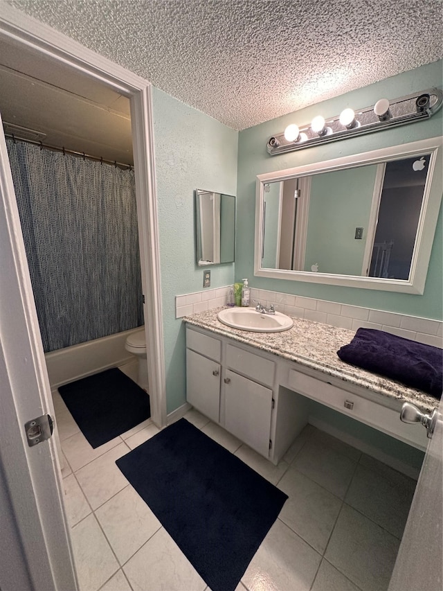 bathroom with vanity, a textured ceiling, toilet, and tile patterned flooring