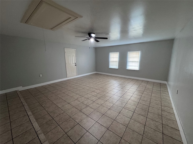 spare room with ceiling fan and light tile patterned flooring