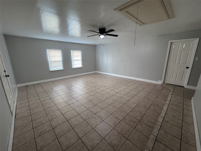 tiled empty room featuring ceiling fan