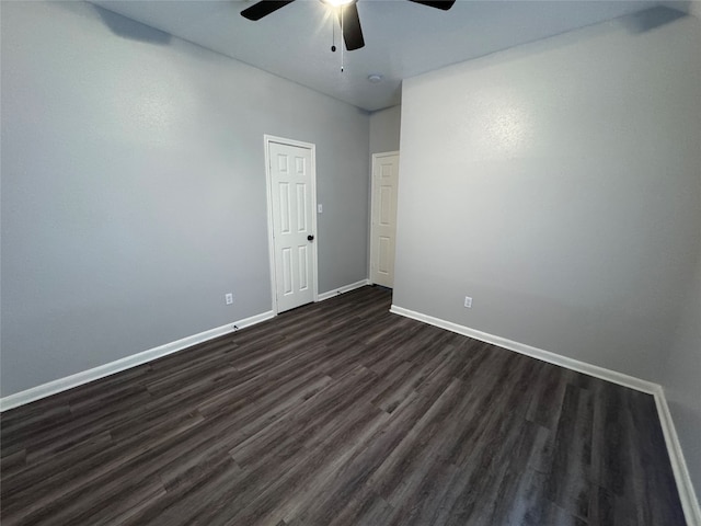 empty room featuring dark hardwood / wood-style floors and ceiling fan