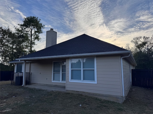 back house at dusk with a patio